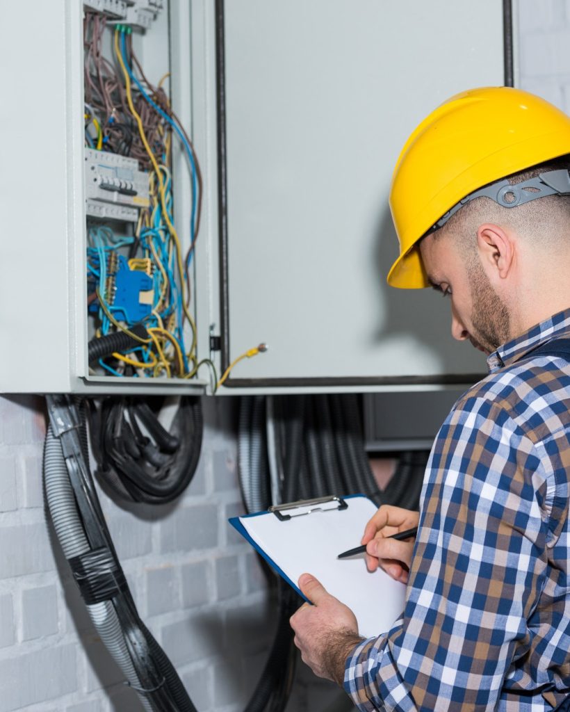 professional-electrician-inspecting-wires-in-electrical-box.jpg
